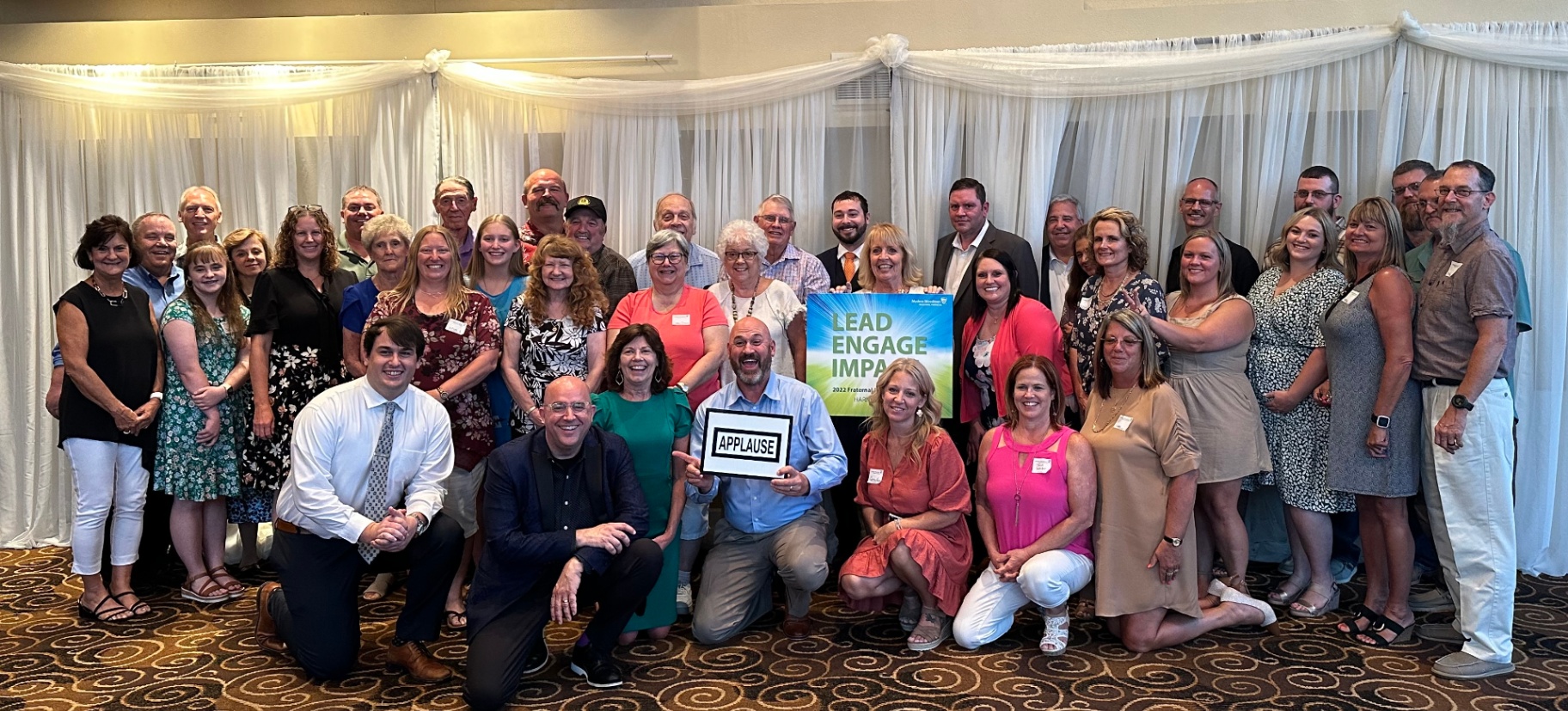 Tim with a full staff team after a keynote event