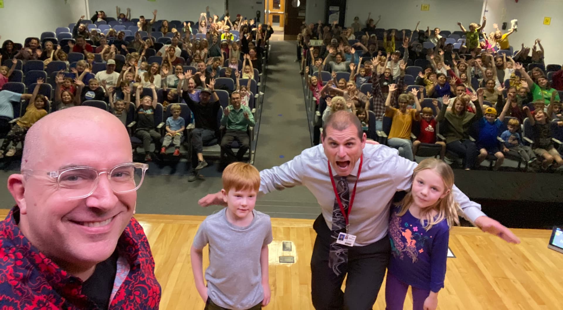The Husmann principal on stage with Tim during Family Night