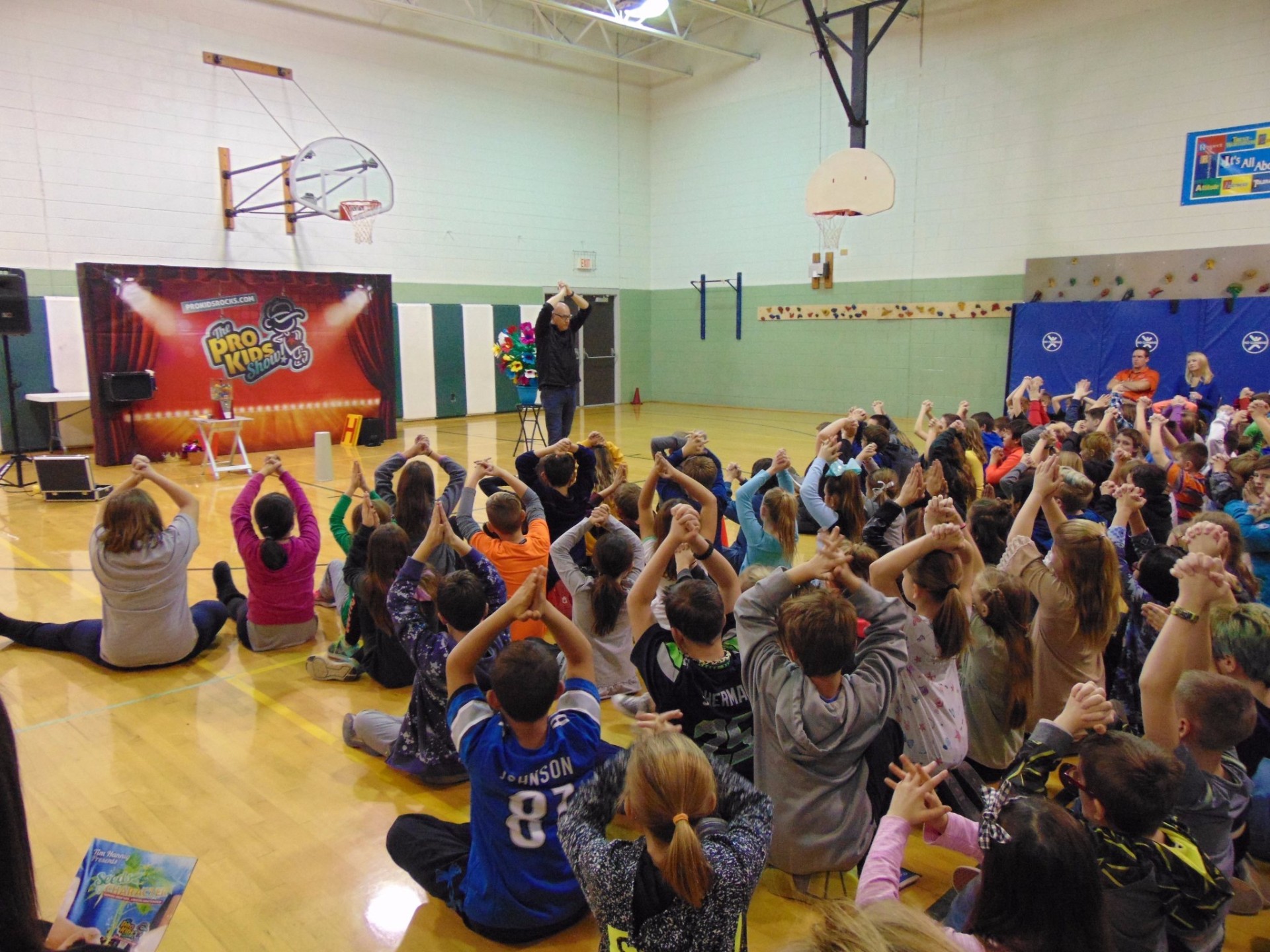 Students packed into a school gym during a Pro-Kids Show assembly