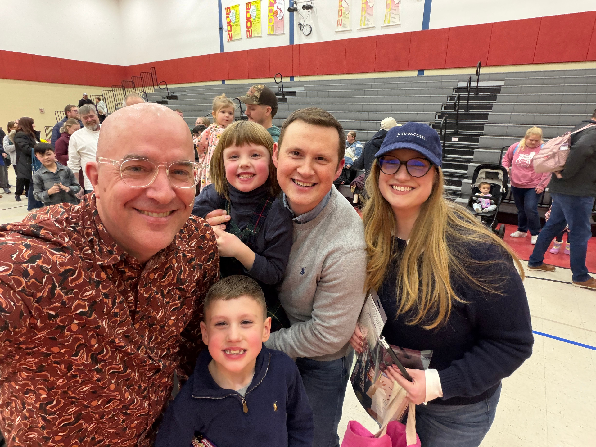 Tim with a happy family at a Lutheran school