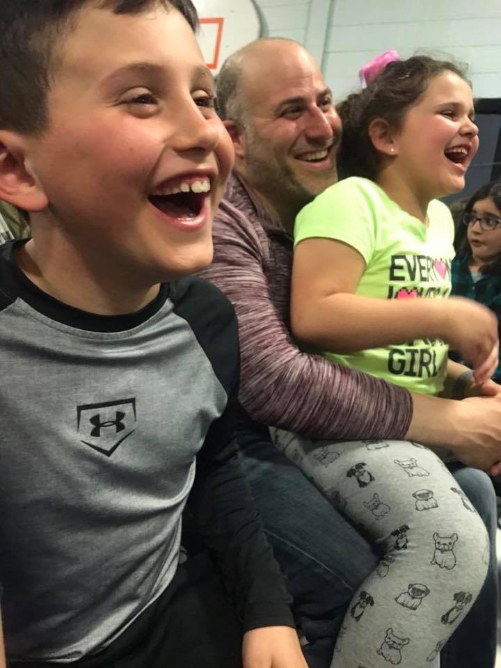 A dad and his two kids laughing during Family Night