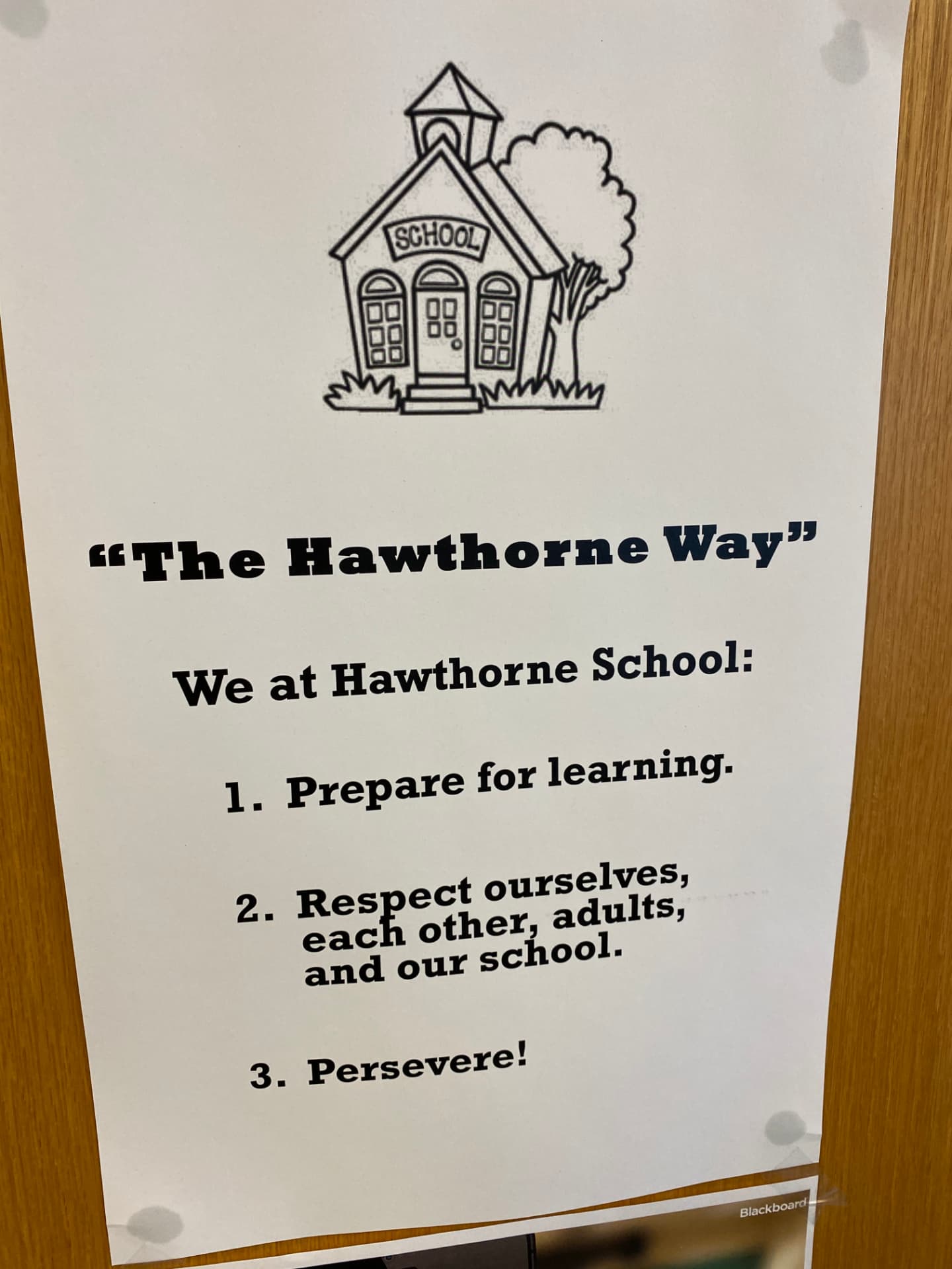 A printed sign titled The Hawthorne Way listing the school's three expectations